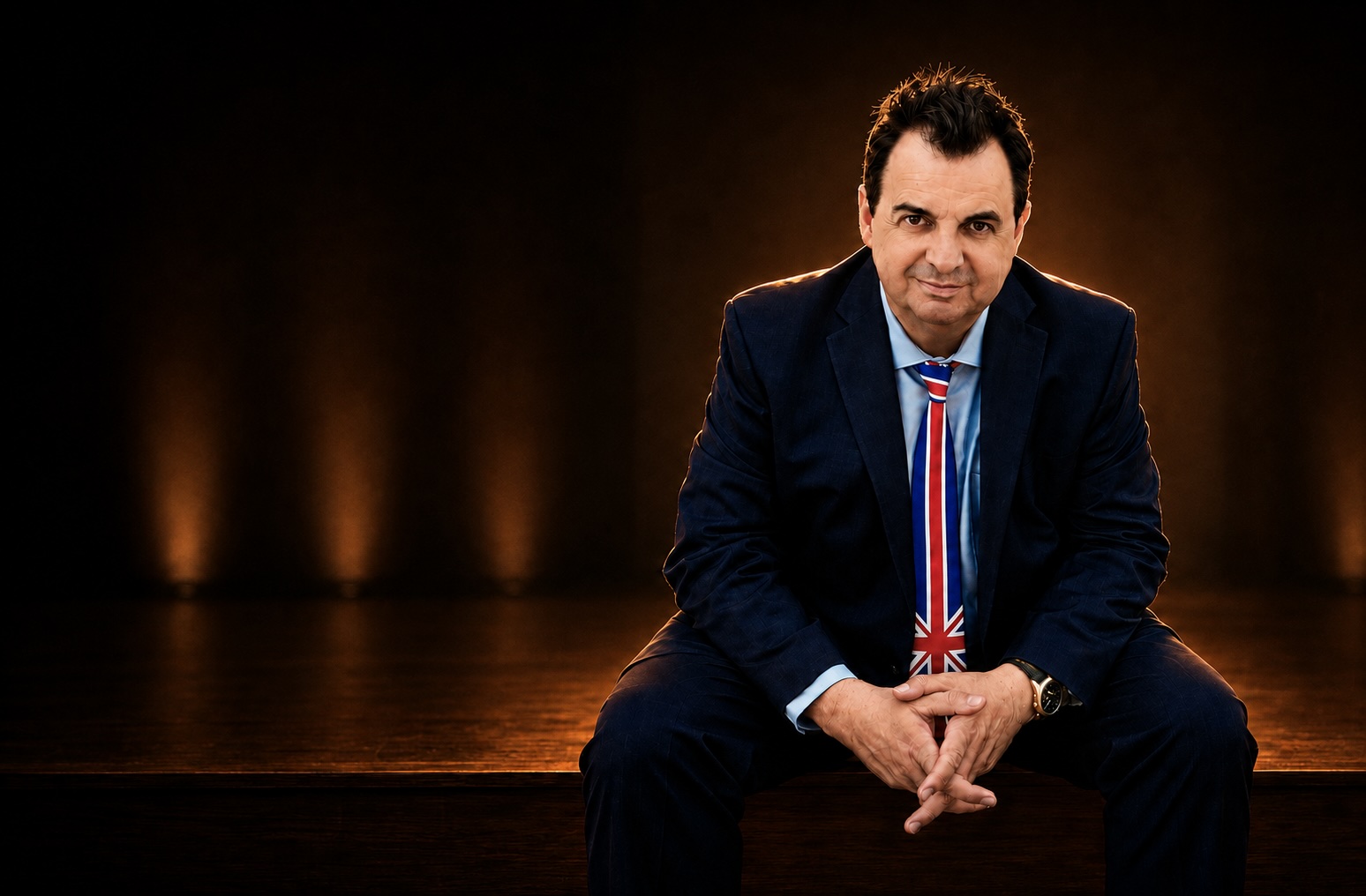 Sandro Monetti seated on stage